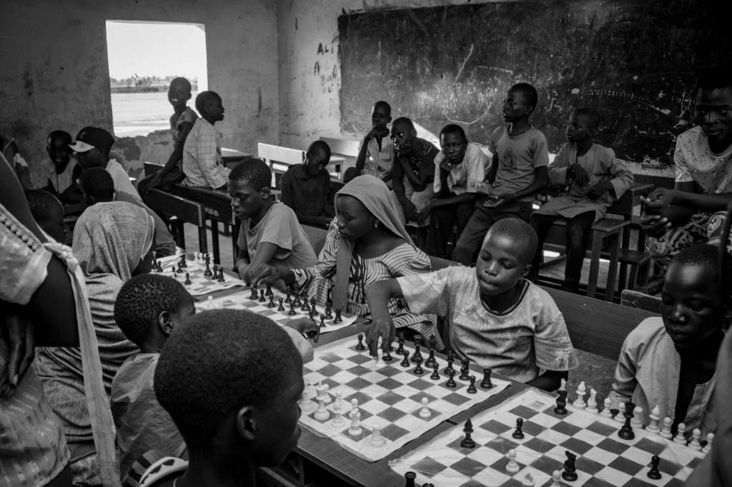 A classroom filled with chess boards and children focusing intently